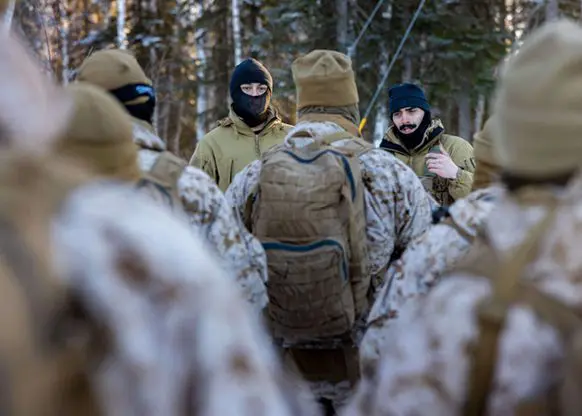Leadership speaking with soldiers for a cold weather class