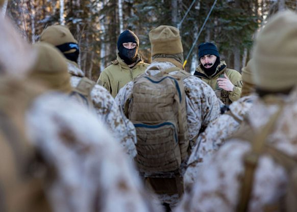 Leadership speaking with soldiers for a cold weather class
